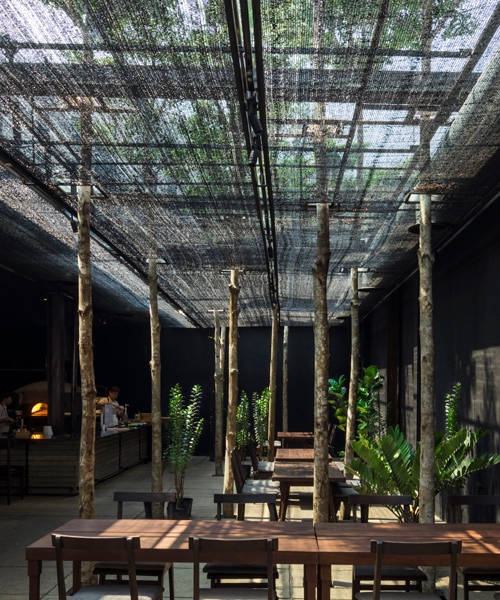 NISHIZAWAARCHITECTS uses agricultural netting to shade diners at vietnam restaurant