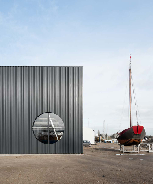 geometric shapes cut through the industrial facade of BETA's amsterdam boat hangar