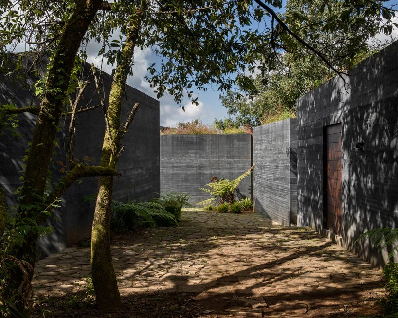 nine individual blocks compose the black concrete bruma house in mexico