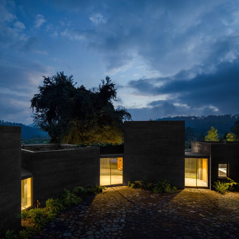 nine individual blocks compose the black concrete bruma house in mexico