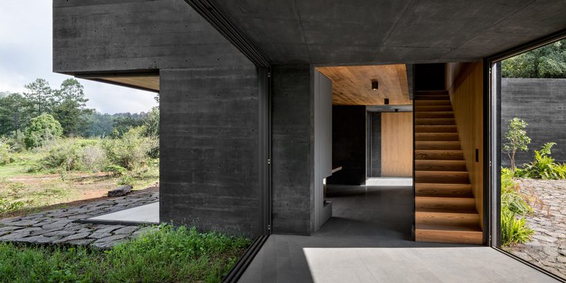 nine individual blocks compose the black concrete bruma house in mexico