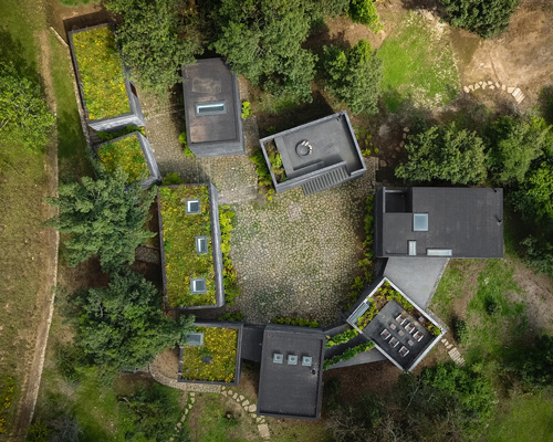 nine individual blocks compose the black concrete bruma house in mexico