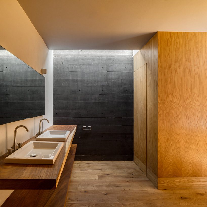 nine individual blocks compose the black concrete bruma house in mexico