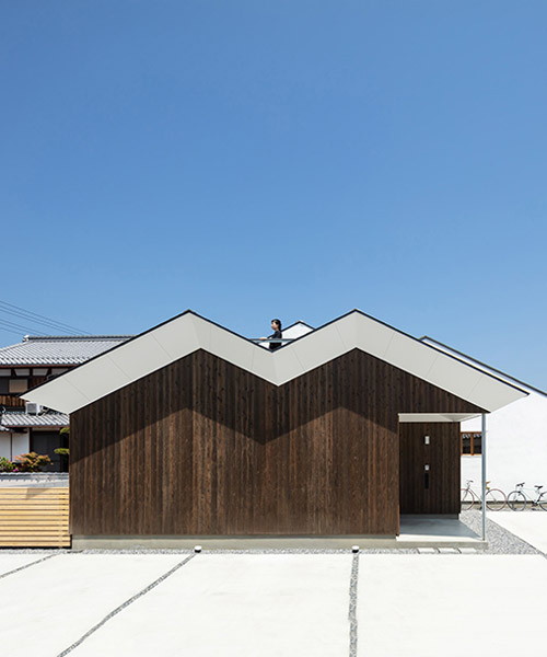 naoko horibe's family house in japanese suburbs merges with surrounding barns