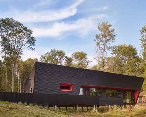 thier + curran architects' retirement dwelling in ontario is clad in black corrugated metal