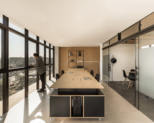 SOLO arquitetos sets an office with a panoramic view of the park in curitiba, southern brazil