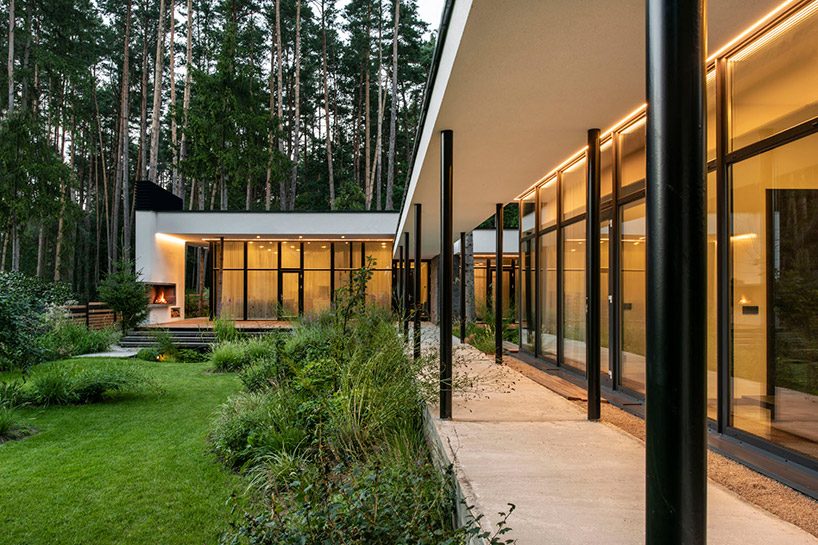 modernist house in lithuanian pine forest bridges a creek, by archLAB