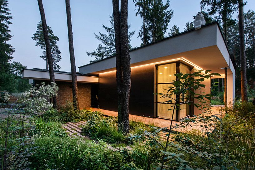 modernist house in lithuanian pine forest bridges a creek, by archLAB