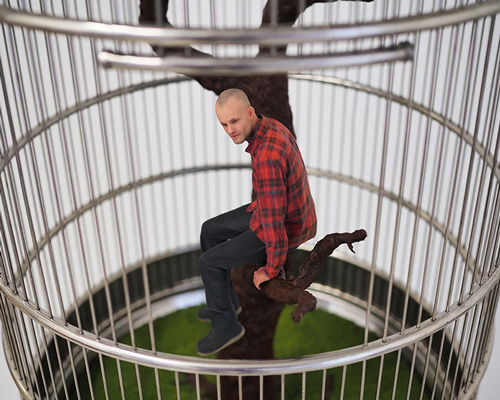 artist imprisons 3D printed 'mini-me' in birdcage to question contemporary ways of living