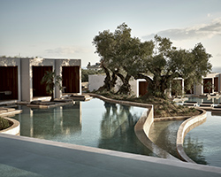 a hotel in greece by block722 surrounds a serene, man-made lake