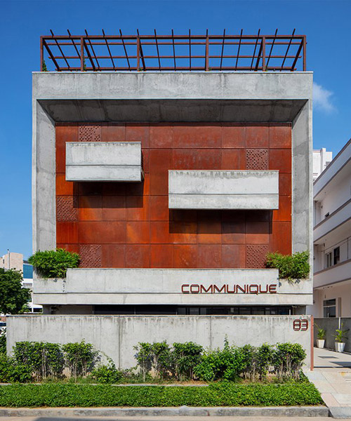a brutalist concrete office building in india punctuated by corten steel, by groupDCA