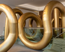 cyril lancelin fills ligne roset store with an inflatable maze of golden arches for LDF 2018
