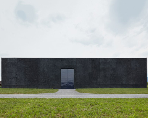 firm uses dark concrete and glimmering metal for groundwater pumping station in austria