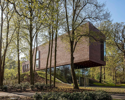 KVDK architects' lisse art museum sits on top of a historic dike in the netherlands