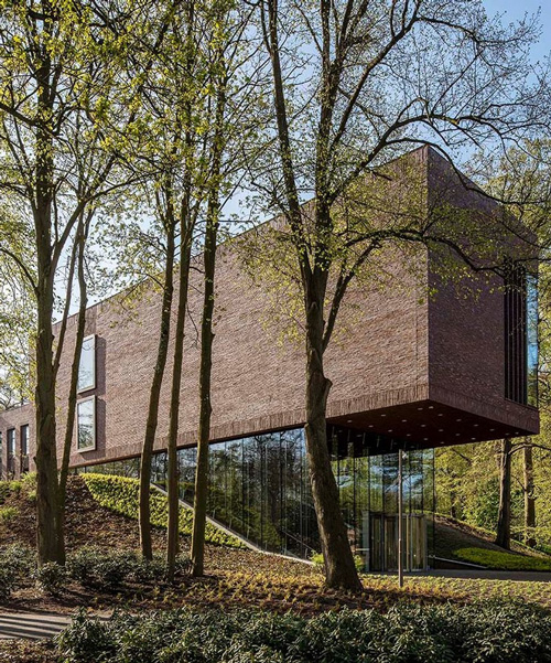 KVDK architects' lisse art museum sits on top of a historic dike in the netherlands