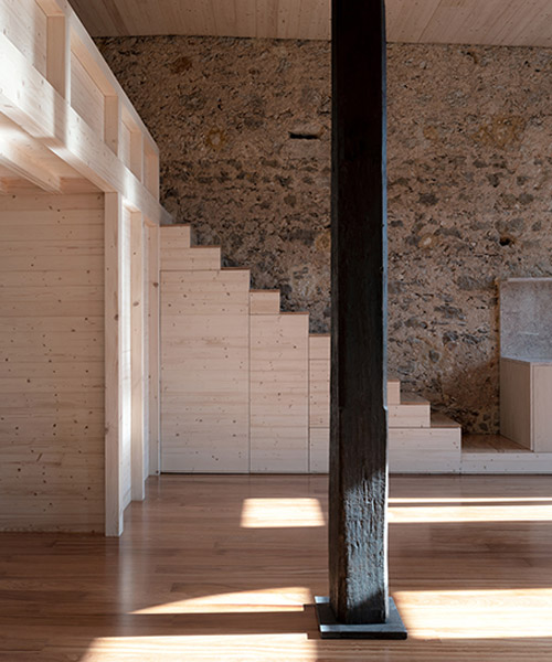 NPS arquitectos turns an early 20th-century building in portugal into a timber loft
