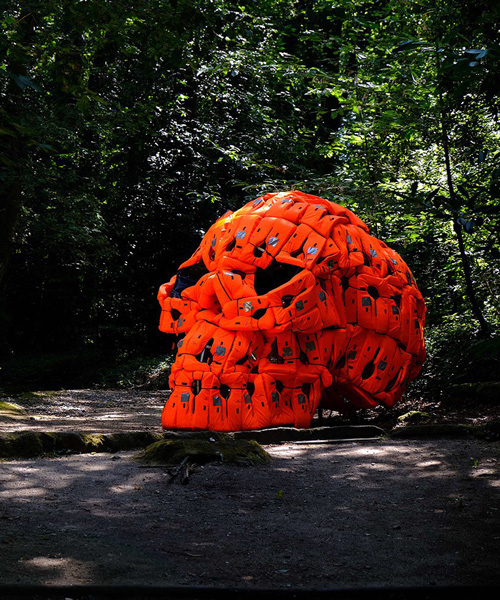 pedro pires sculpts large-scale skull using 140 life vests and rubber from a refugee dinghy