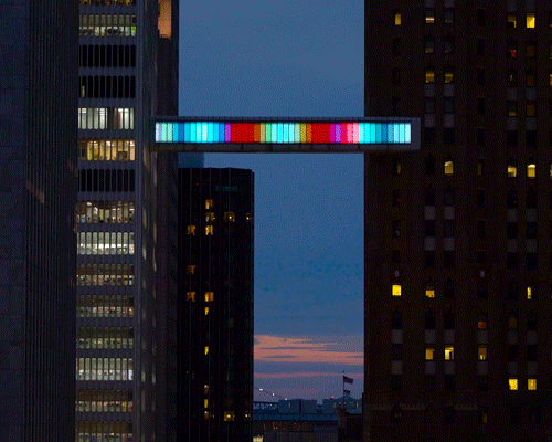 phillip k. smith III creates 'floating bar of light' for detroit skybridge