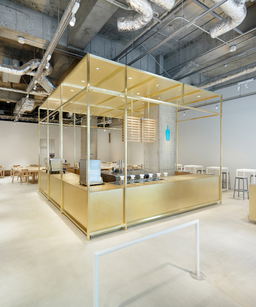 schemata focuses design for first blue bottle cafe in kobe around a central brass structure