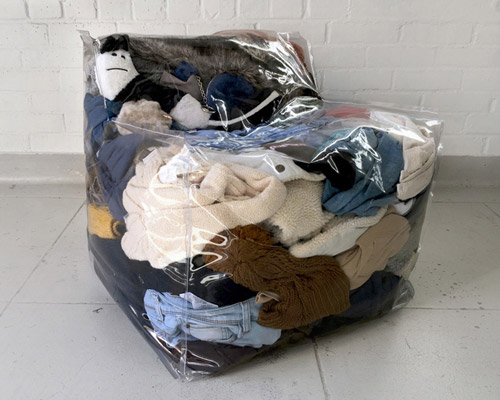 transparent vinyl chair by zhihao guo is stuffed with clothes