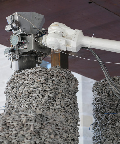 construction robot builds 'rock print pavilion' using loose stones and string