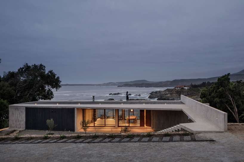 felipe assadi casa cipolla overlooks the rocky shoreline of a chilean lake