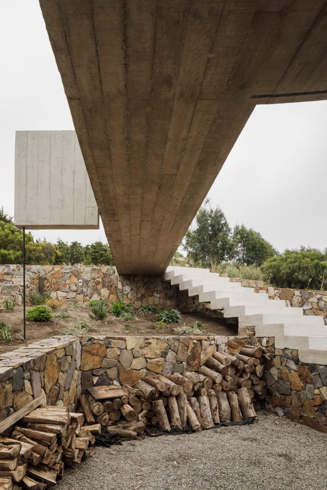 felipe assadi casa cipolla overlooks the rocky shoreline of a chilean lake