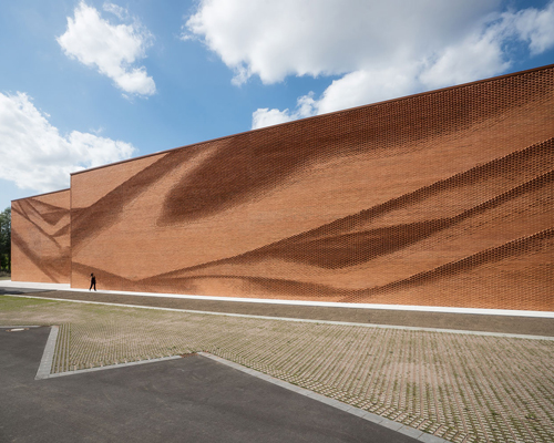 this undulating brick façade imitates the movement of draped fabric