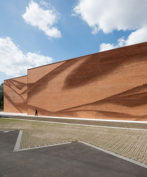 this undulating brick façade imitates the movement of draped fabric