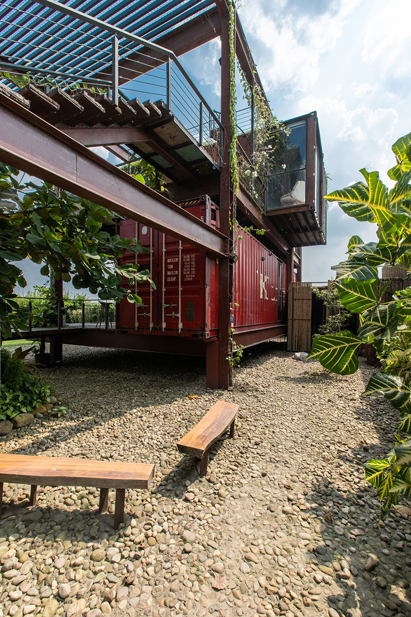 river & rain combines recycled shipping containers into three-story residence in dhaka