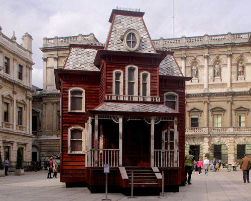 the sinister 'psychobarn' by cornelia parker takes up residence in london