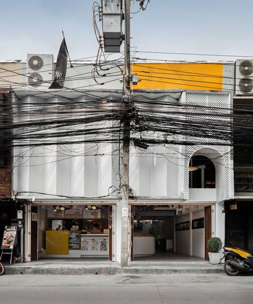 fattstudio renovates bento bar in bangkok with a perforated façade and hidden courtyard