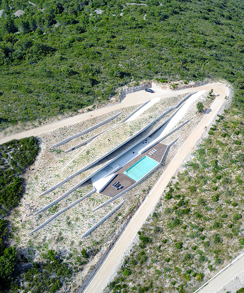 proarh envisions concrete family retreat as artificial grotto on the croatian island of vis
