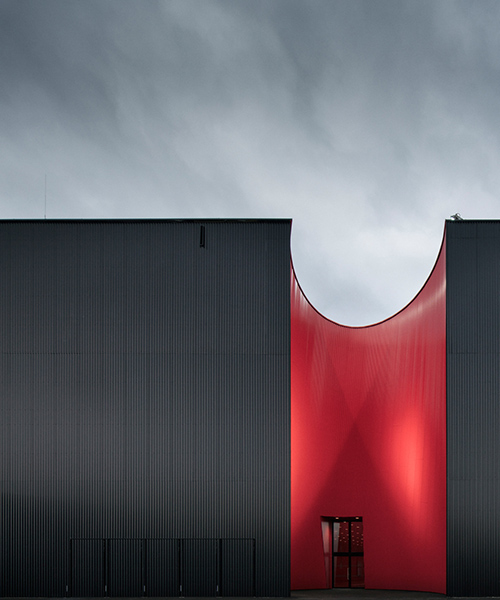 marte marte architects presents dramatic exhibition hall in red and black