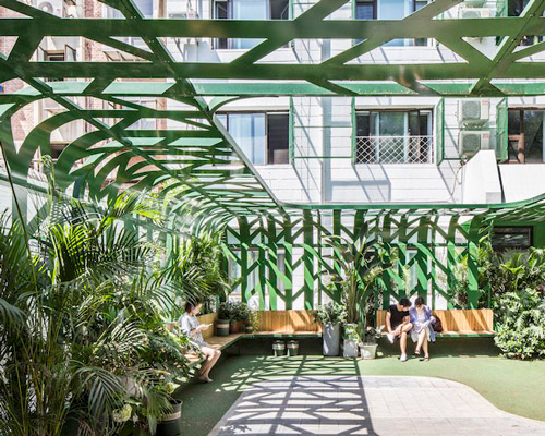 MAT office's courtyard in beijing is fenced by green steel canopy imitating trees