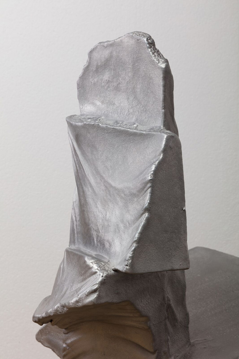 max lamb carves ‘prehistoric' objects from polystyrene then coats them with aluminum paint