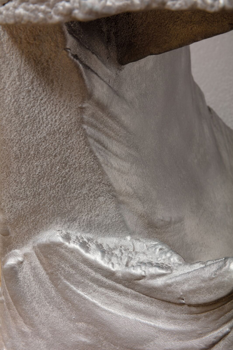 max lamb carves ‘prehistoric' objects from polystyrene then coats them with aluminum paint