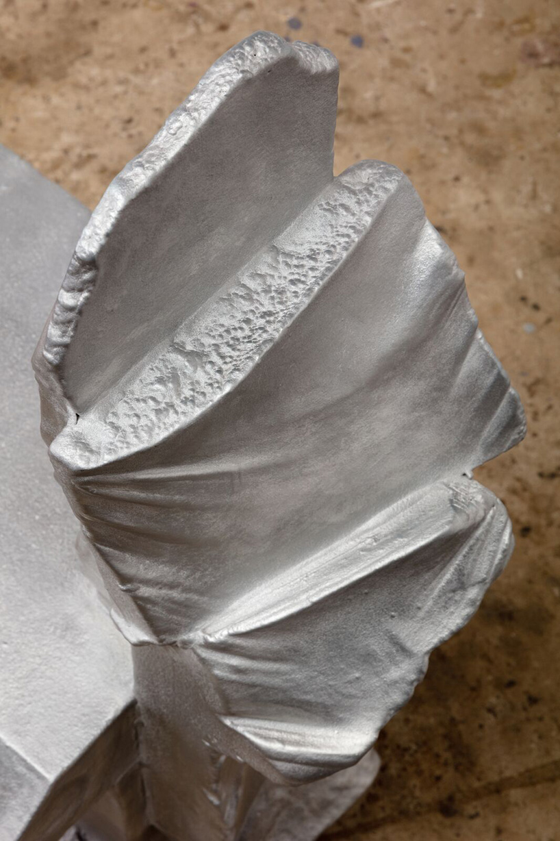 max lamb carves ‘prehistoric' objects from polystyrene then coats them with aluminum paint