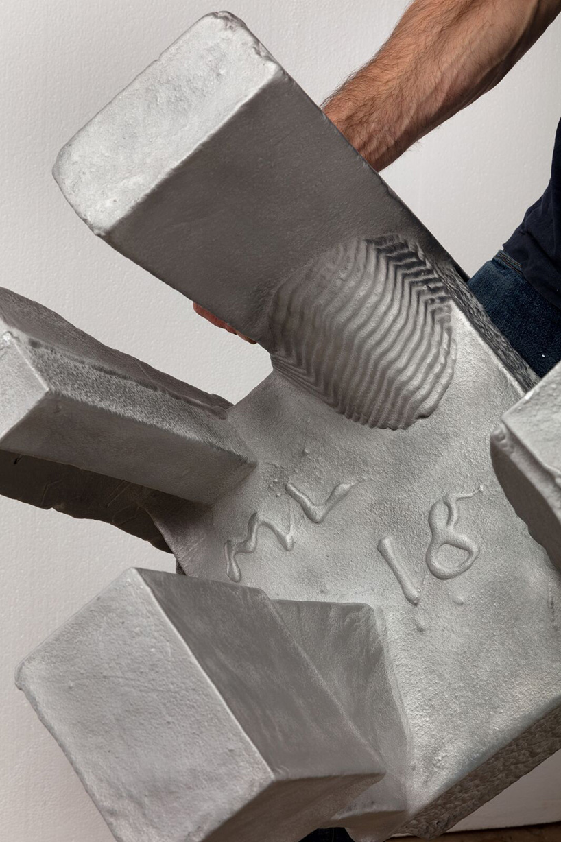 max lamb carves ‘prehistoric' objects from polystyrene then coats them with aluminum paint