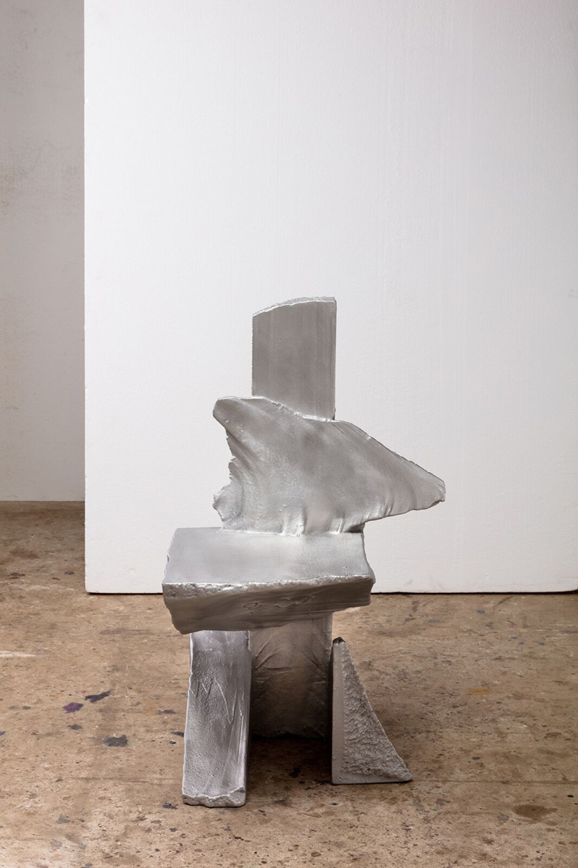 max lamb carves ‘prehistoric' objects from polystyrene then coats them with aluminum paint