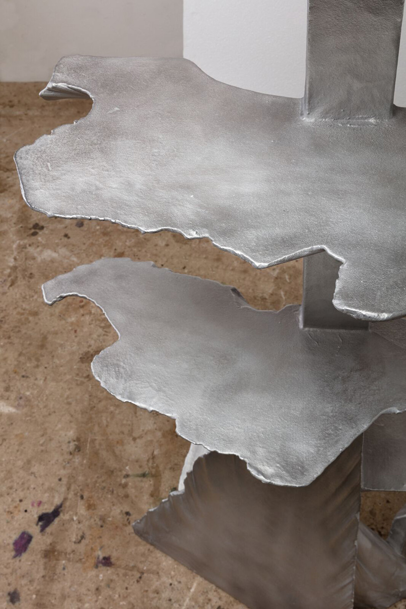 max lamb carves ‘prehistoric' objects from polystyrene then coats them with aluminum paint