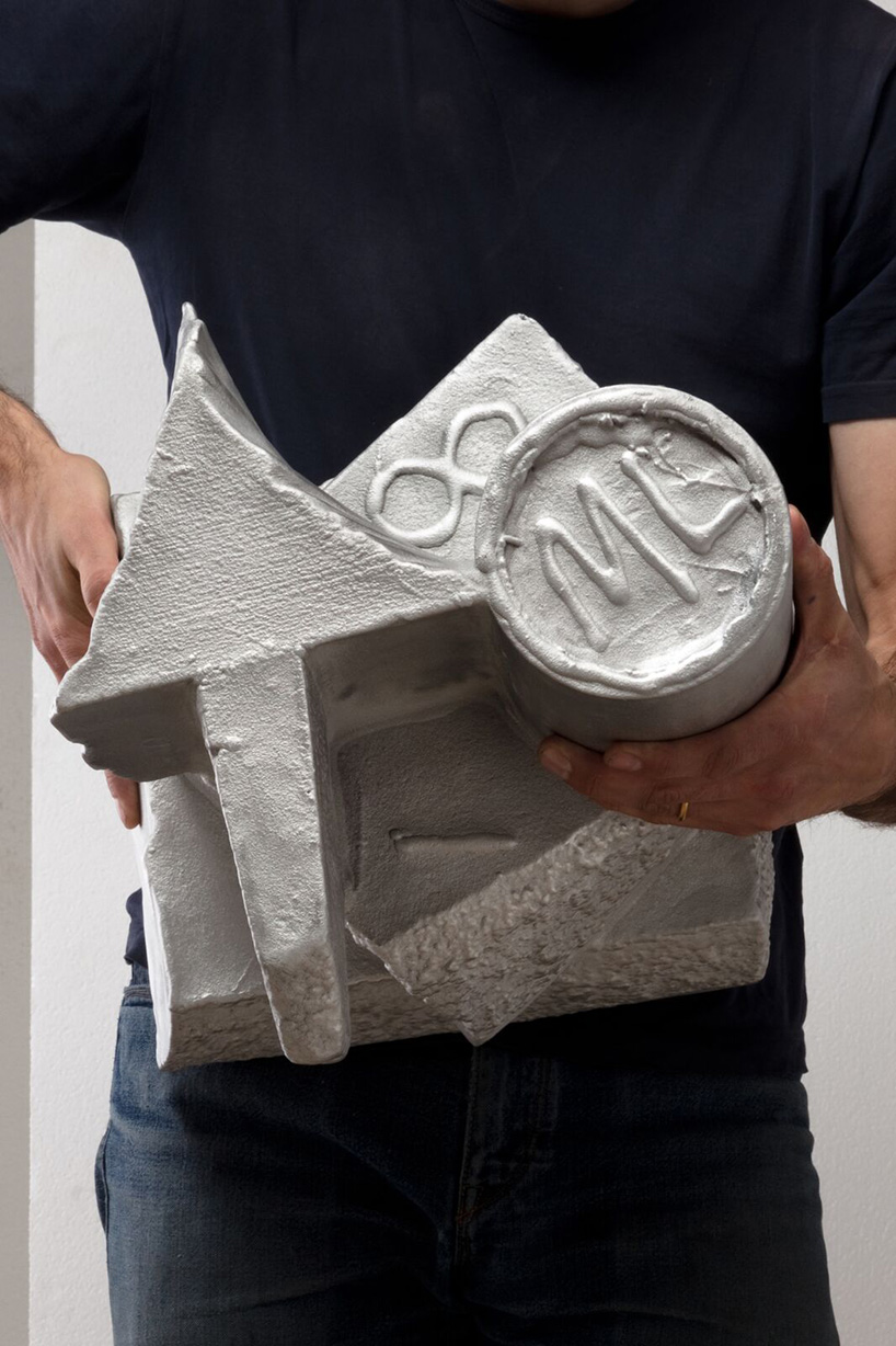max lamb carves ‘prehistoric' objects from polystyrene then coats them with aluminum paint