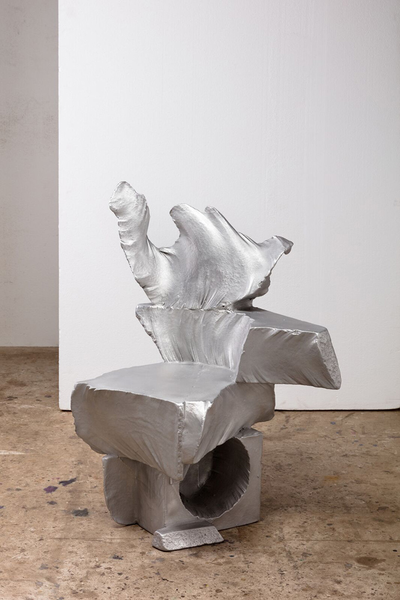 max lamb carves ‘prehistoric' objects from polystyrene then coats them with aluminum paint
