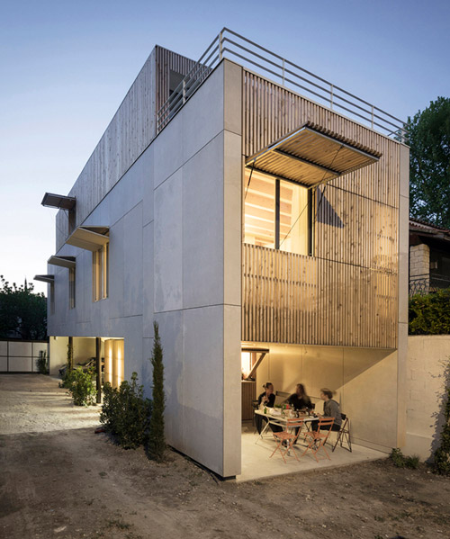 this concrete building in france by raphael azalbert is decorated with light wooden grills