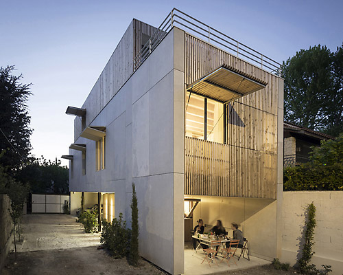 this concrete building in france by raphael azalbert is decorated with light wooden grills