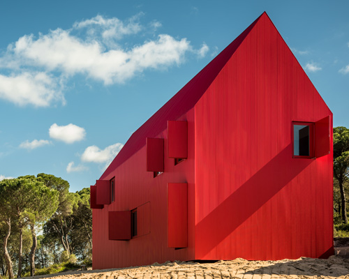 this bright red house in portugal has been designed to stand out