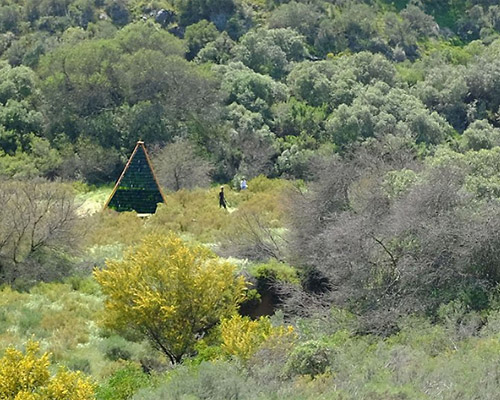 follies in the veld pavilion by theMAAK in south africa is made of over 1000 reused bottles