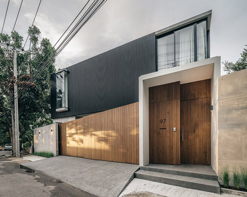 anonym studio combines wood, concrete and metal in a family residence in bangkok