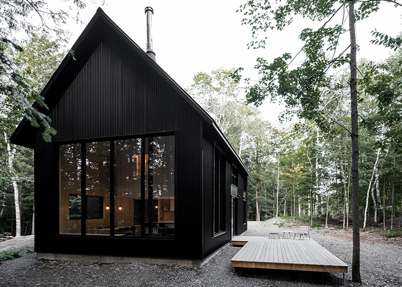 two steel  black cabins form striking quebec chalet by 