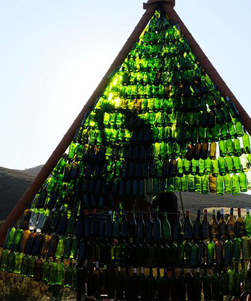 follies in the veld pavilion by theMAAK in south africa is made of over 1000 reused bottles